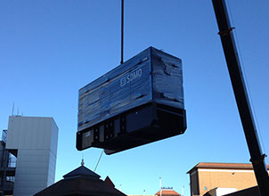 A generator being crained onto a building top and installed for a local council by Enhanced Power Services Ltd