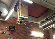 UPS (uninterruptible power supply) being hoisted up and through a small opening during installation by Enhanced Power Services Ltd.